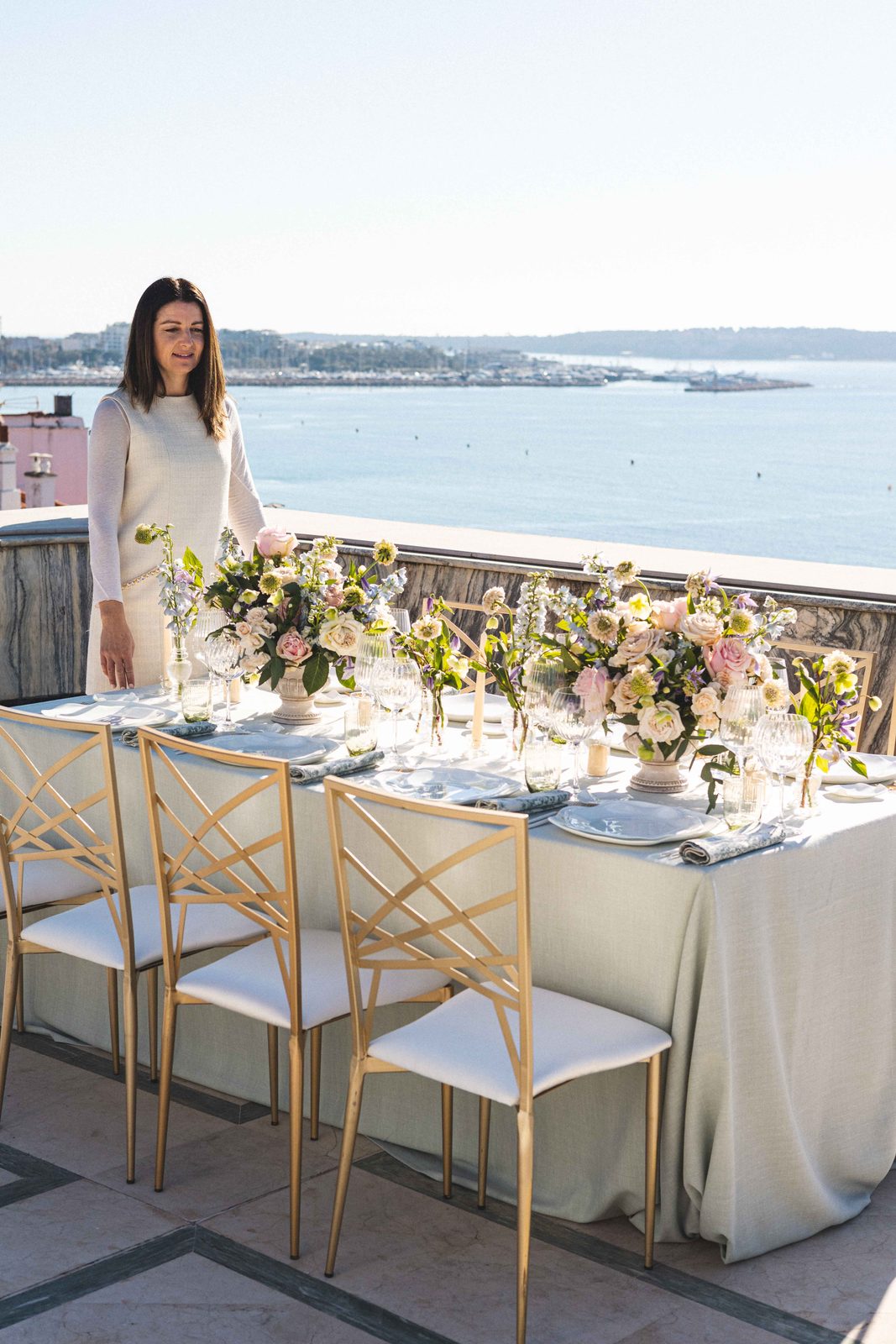 A table laid on a terrace above the bay of Cannes